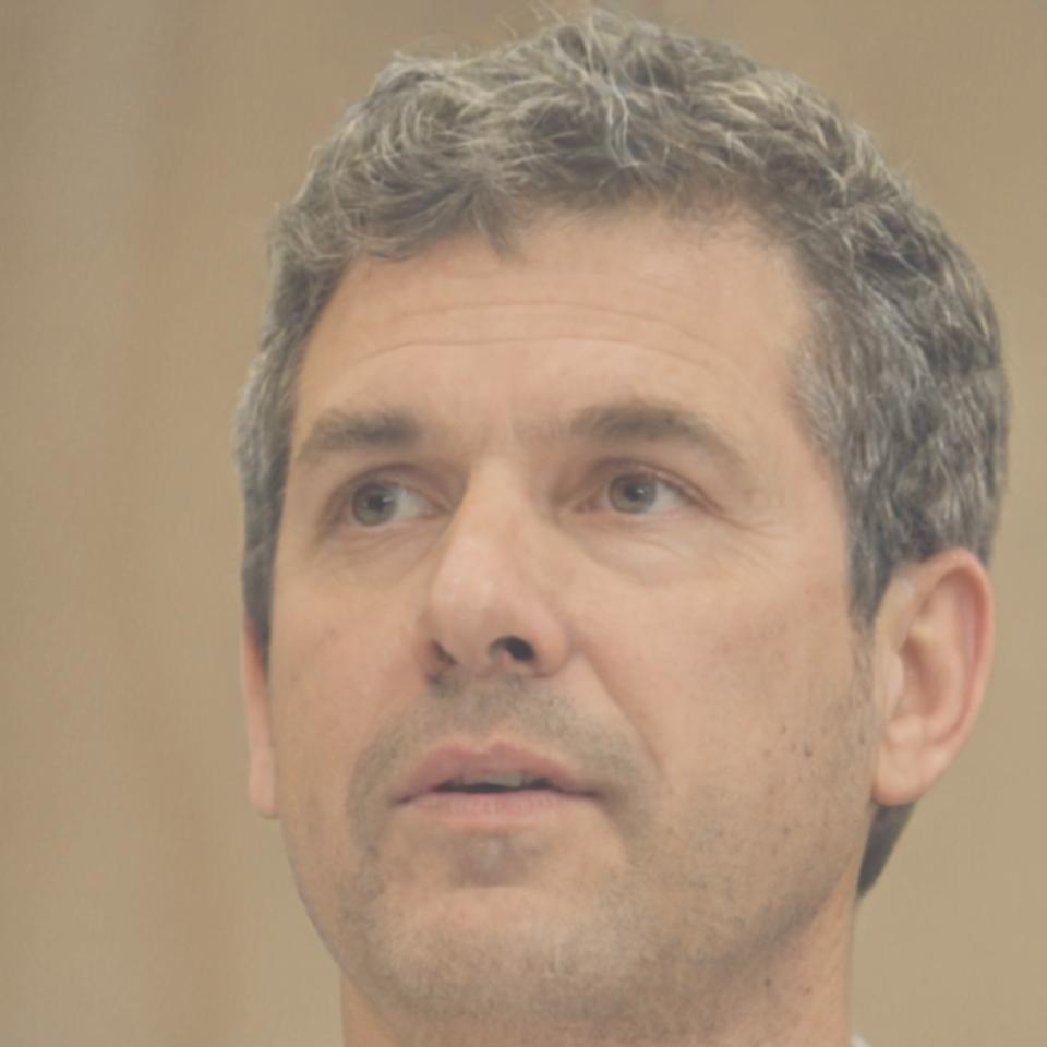 Professional headshot of budget analysis expert